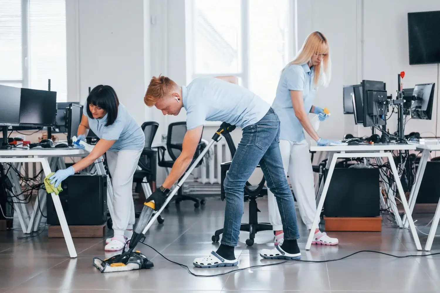 Cleaners working in a brightly lit office